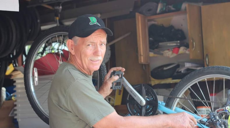 Charlie Gau works on a bike in West Carrollton. CONTRIBUTED