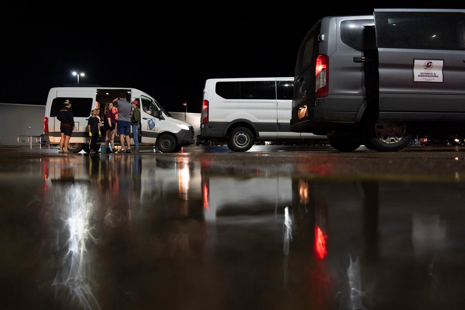 Members of Project ICECHIP gather in the Walmart parking lot to measure, weigh and crush hail during an operation late Friday, June 6, 2025, in Levelland, Texas. (AP Photo/Carolyn Kaster)