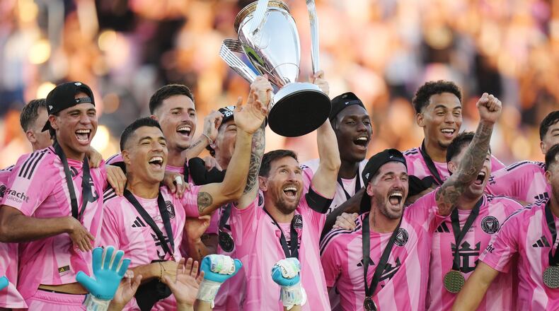 Inter Miami's Lionel Messi hoists the trophy alongside teammates after defeating the Vancouver Whitecaps in the MLS Cup final soccer match, in Fort Lauderdale, Fla., Saturday, Dec. 6, 2025. (Darryl Dyck/The Canadian Press via AP)
