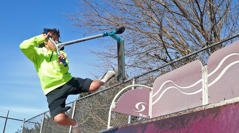 The 35 degree temperature didn't seem to bother Brayden Wiley, 13, as he practiced tricks on his scooter Monday morning at the New Carlisle skate park. The weather is supposed to stay cool all week with rain possible on Thanksgiving day. BILL LACKEY/STAFF