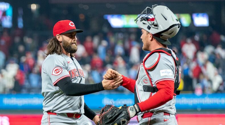 Cincinnati Reds relief pitcher Tejay Antone, left, celebrates the win with catcher Luke Maile, right, following a baseball game against the Philadelphia Phillies, Monday, April 1, 2024, in Philadelphia. (AP Photo/Chris Szagola)
