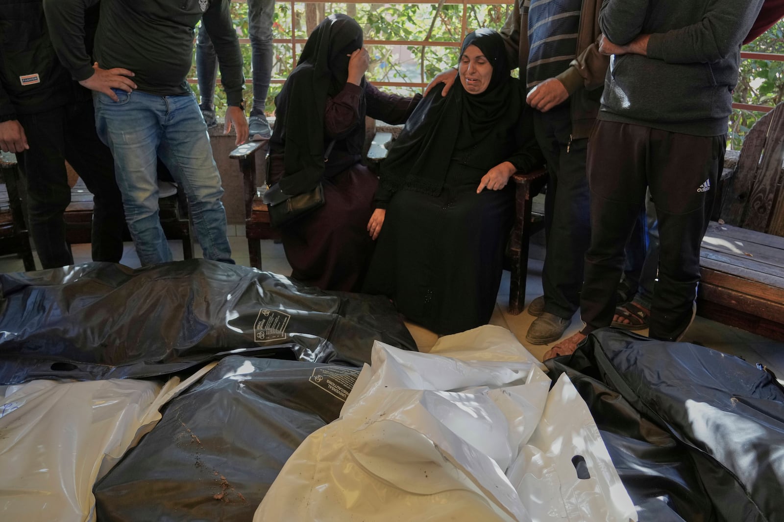 Relatives Mourn over the bodies of 10 members of the Abu Al-Rous family, killed when an Israeli airstrike struck their displacement tent overnight, during their funeral in Khan Younis, southern Gaza Strip, Thursday, April 17, 2025. (AP Photo/Abdel Kareem Hana)