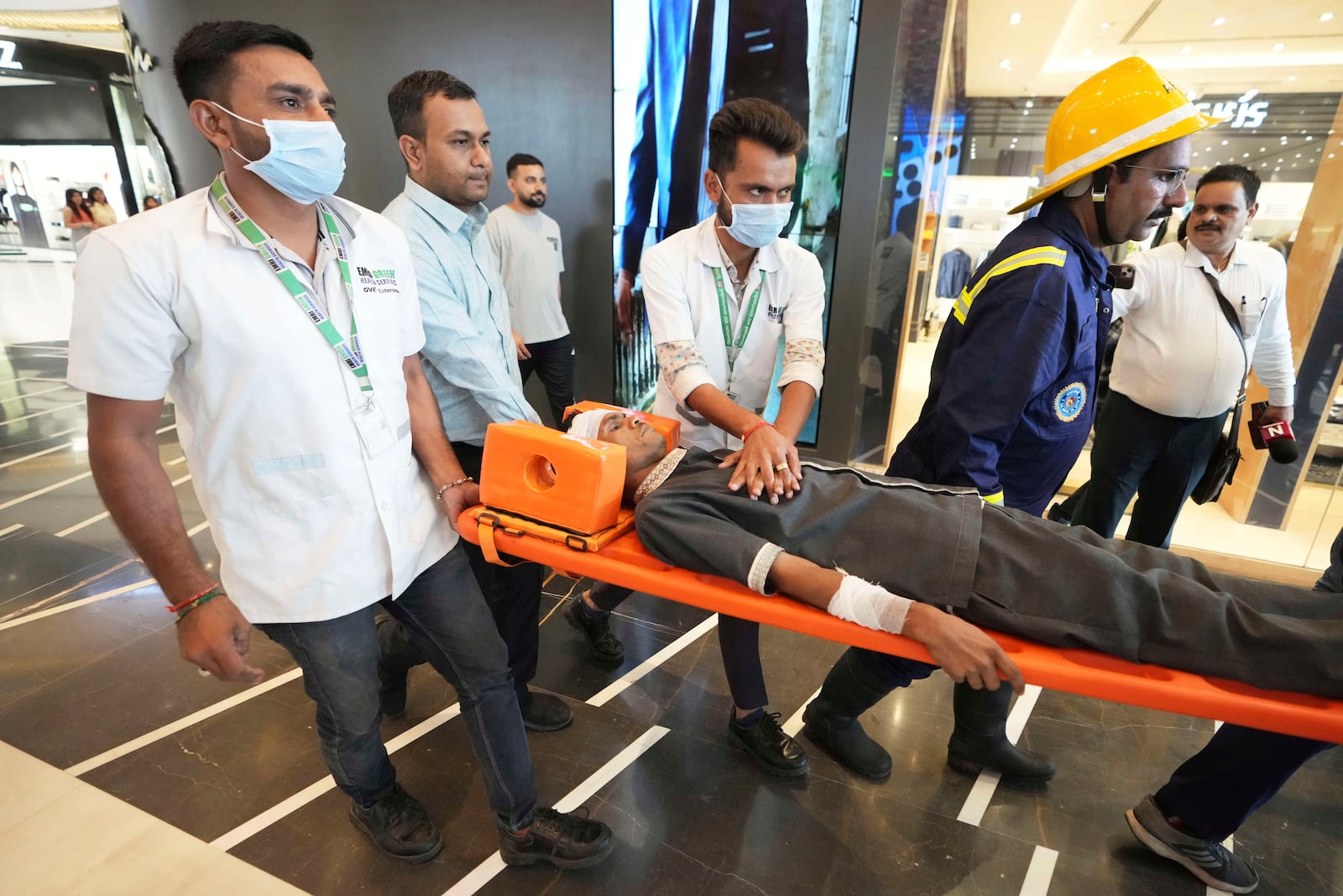 Fire brigade workers and paramedics participates in a security mock drill at a mall in Ahmedabad, India, Wednesday, May 7, 2025, amid rising fears of wider conflict following India's strikes in Pakistan. (AP Photo/Ajit Solanki)