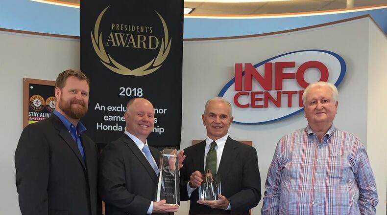 L to R: Brad Voss, Craig Voss, Roger Quant and John Voss celebrate Voss Honda s win of Honda President s Award for 2018, the 20th consecutive time the Tipp City dealership has achieved such a distinction. AMY ROLLINS/STAFF