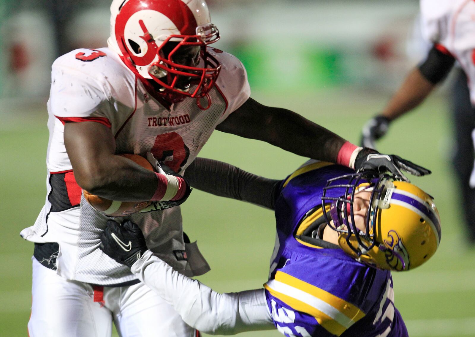 Trotwood Madison's Isreal Green runs against Avon's Kevin Skotko in the second quarter in the Division II high school state championship football game, Friday, Dec. 2, 2011, in Massillon, Ohio. (AP Photo/Tony Dejak)