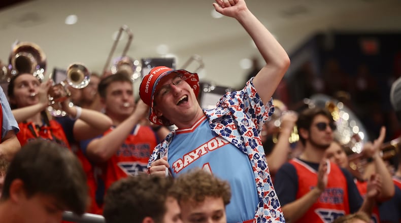A fan in the Red Scare student section cheers during an exhibition game between Dayton and Penn State on Sunday, Oct. 19, 2025, at UD Arena. David Jablonski/Staff