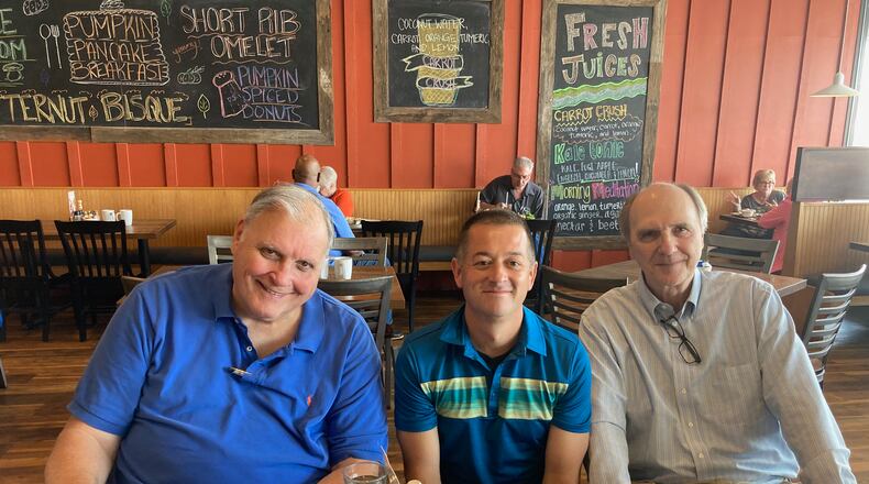 David Jablonski, center, poses for a photo with former Dayton Flyers George Janky and Ken May in 2021.