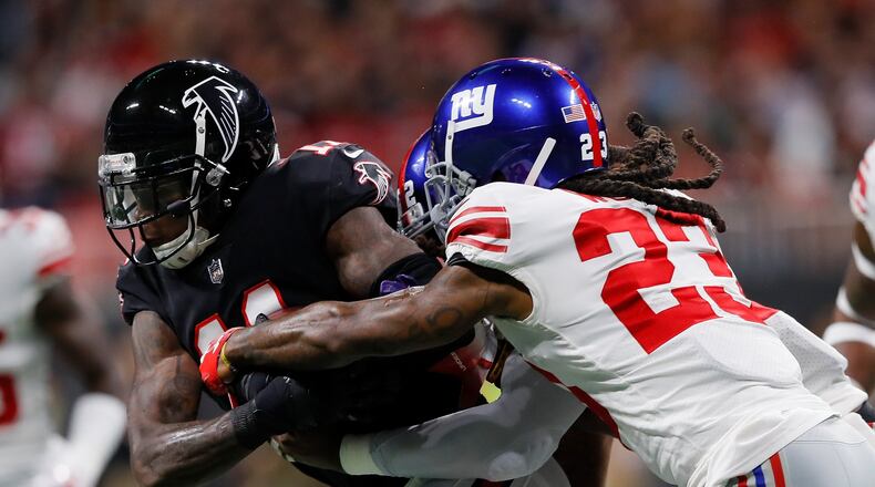 ATLANTA, GA - OCTOBER 22: Julio Jones #11 of the Atlanta Falcons is tackled by B.W. Webb #23 of the New York Giants and Alec Ogletree #52 of the New York Giants after carrying a reception during the second quarter against the New York Giants at Mercedes-Benz Stadium on October 22, 2018 in Atlanta, Georgia. (Photo by Kevin C. Cox/Getty Images)