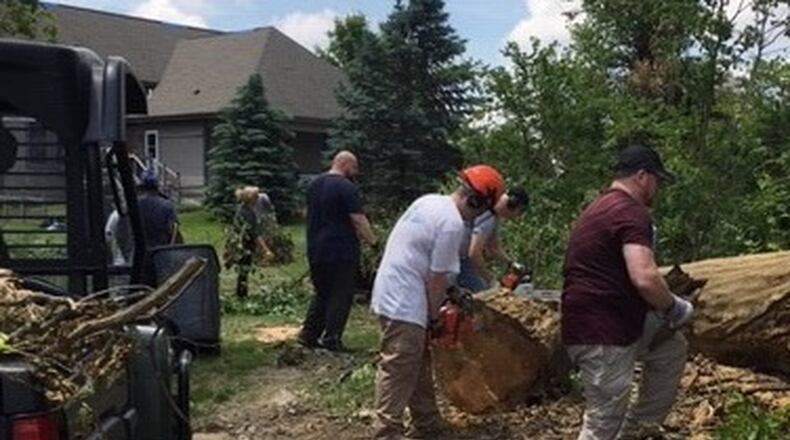 Neighbors and coworkers of Mike and Loni Roberts helped to remove debris from their property after an EF 4 tornado tore through Brookville on Memorial Day. The Roberts’ garage was destroyed and part of their roof was ripped off.