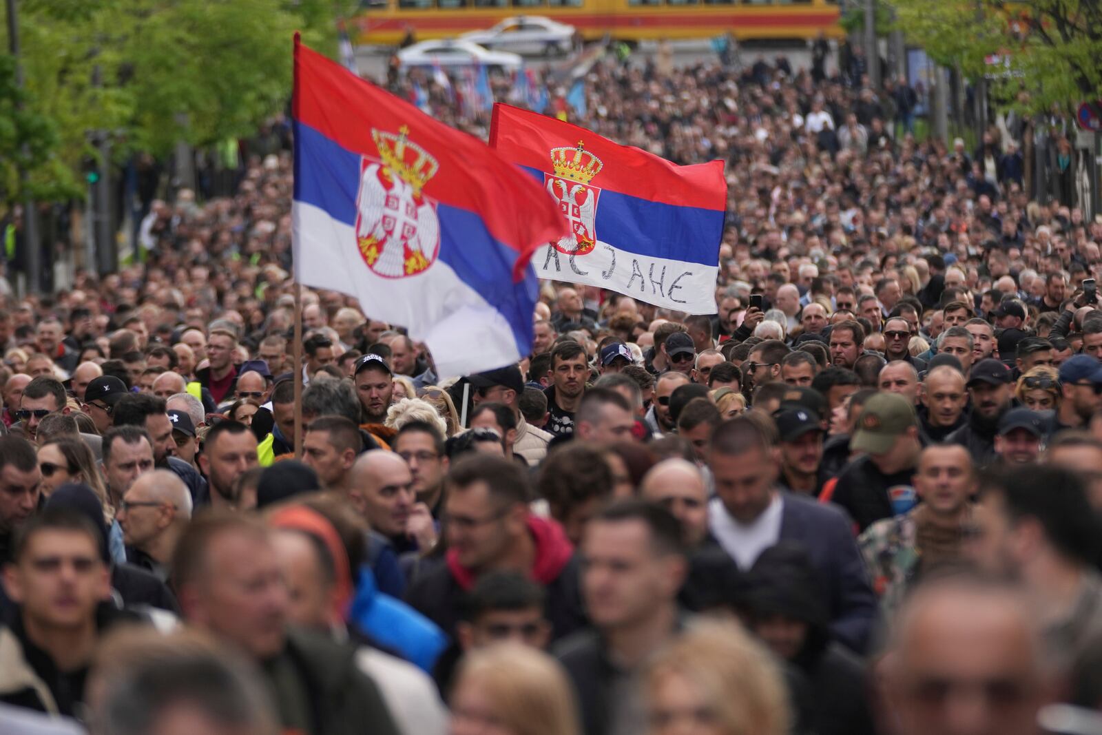 People march ahead of a big counter-opposition protest rally planned to stage over the weekend in downtown Belgrade, Serbia, Friday, April 11, 2025. (AP Photo/Darko Vojinovic)