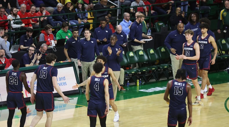 Dayton's Anthony Grant claps at the end of the first half against George Mason on Wednesday, Feb. 21, 2024, at EagleBank Arena in Fairfax, Va. David Jablonski/Staff
