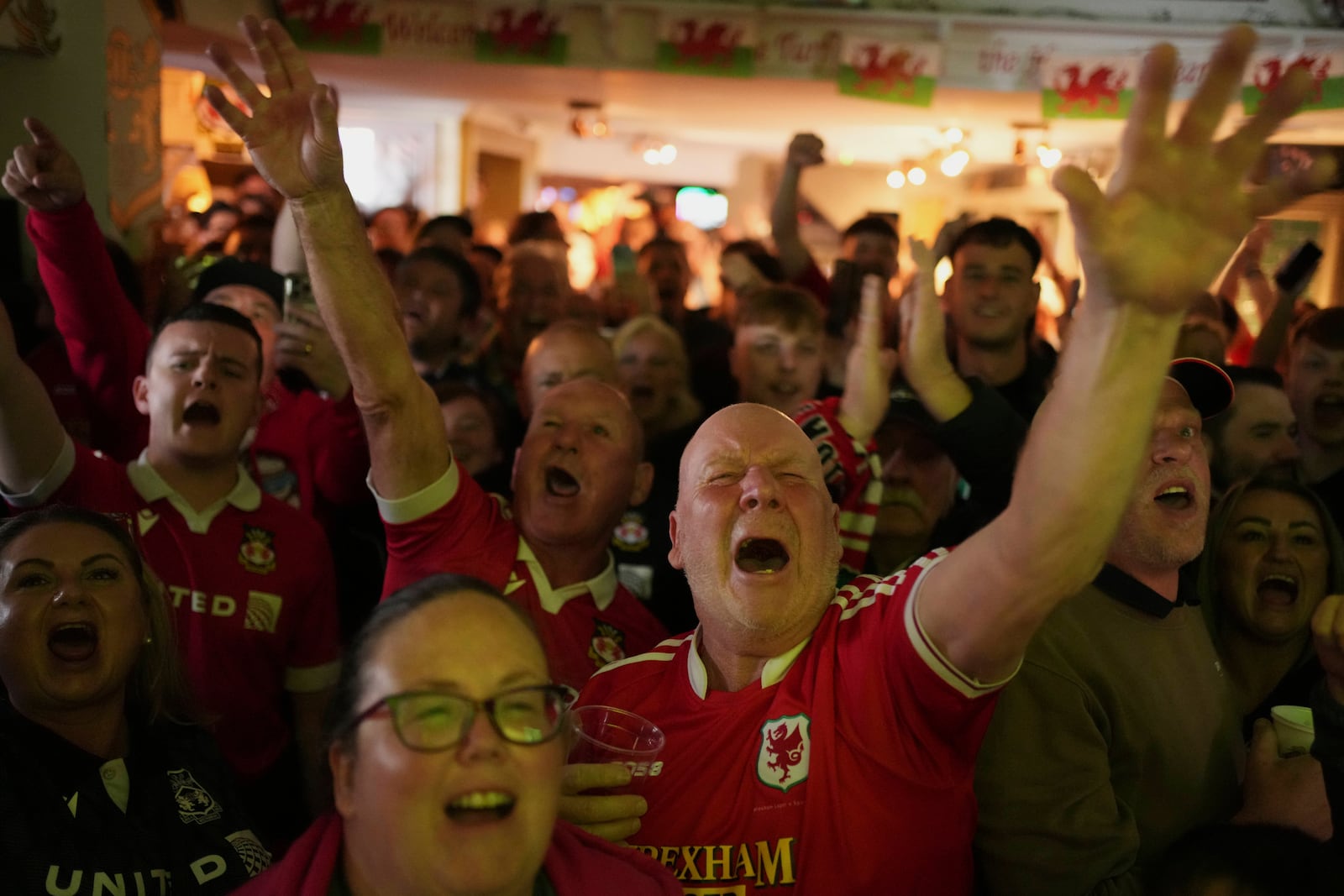 Wrexham supporters cheer prior the English League One soccer match between Wrexham and Charlton Athletic at the Racecourse ground in Wrexham, Wales, Saturday, April 26, 2025. (AP Photo/Jon Super)