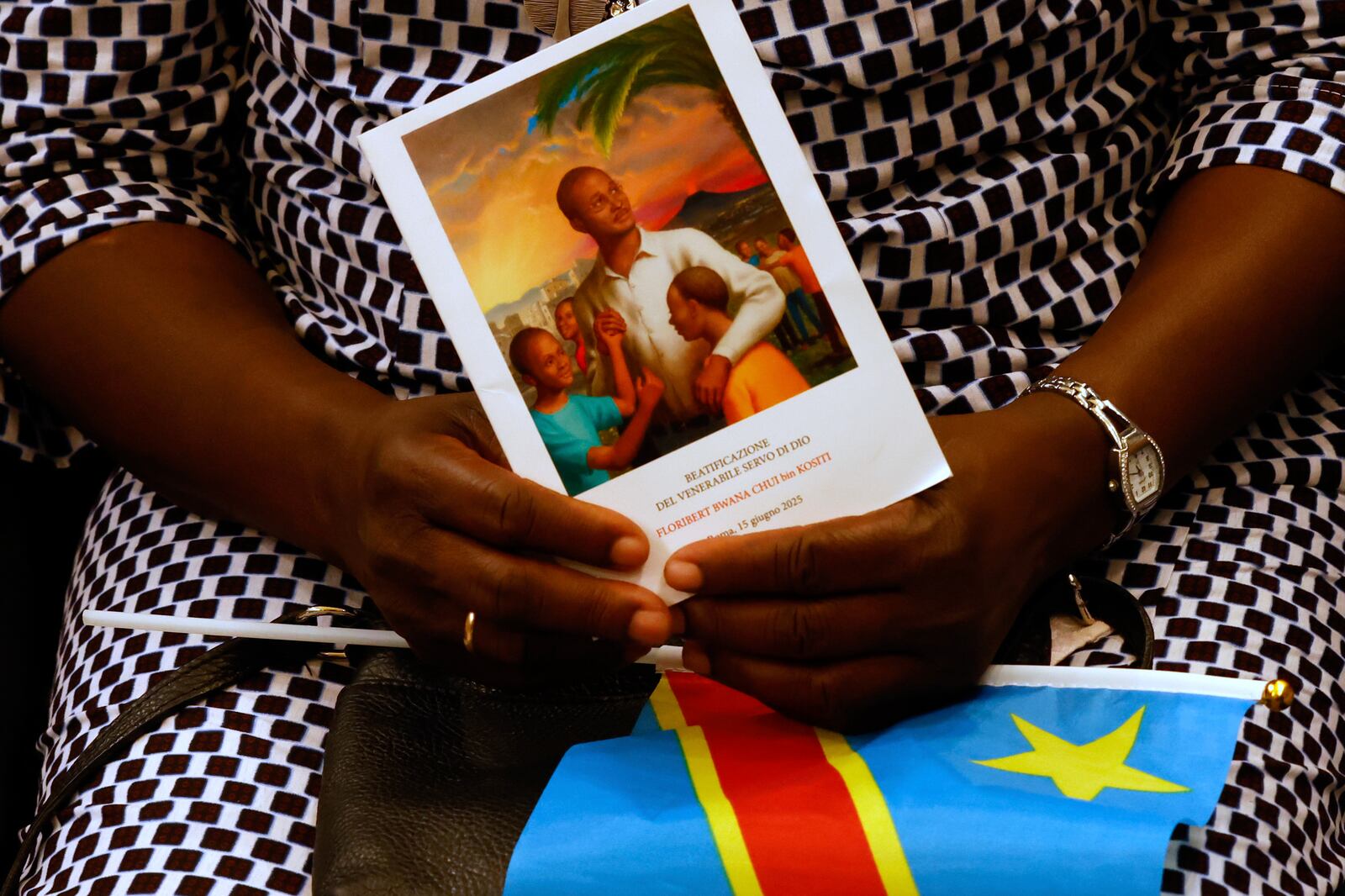 Faithful wait for the start of a beatification ceremony of Floribert Bwana Chui Bin Kositi, a Congolese man killed in 2007 for fighting corruption, in St. Paul Outside the Walls' Basilica, in Rome, Sunday, June 15, 2025. (AP Photo/Riccardo De Luca)
