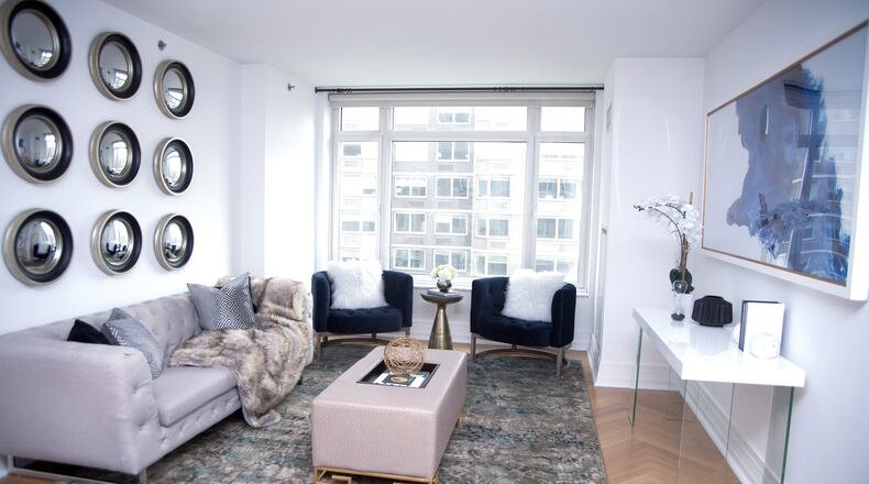 Round mirrors placed in rows serve as artwork in this living room. (Handout/TNS)
