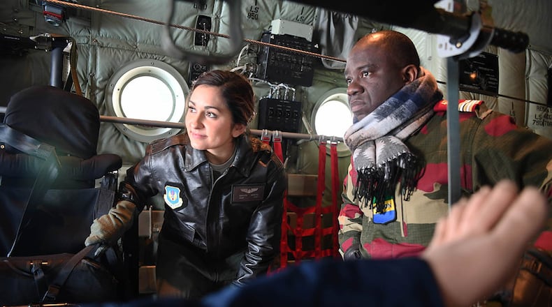 U.S. Air Force Staff Sgt. Marissa Morgan, 86th Aeromedical Evacuation Squadron aeromedical technician, and Gabonese air force Capt. Herve Batamio, prepare to load a patient on to a C-130J Super Hercules at Ramstein Air Base, Germany, Jan. 18. Thirteen countries gathered at Ramstein AB to exchange aeromedical tactics, techniques, and procedures to encourage working relationships between the nations during a week-long symposium. (U.S. Air Force photos/Tech. Sgt. Rachelle Coleman)