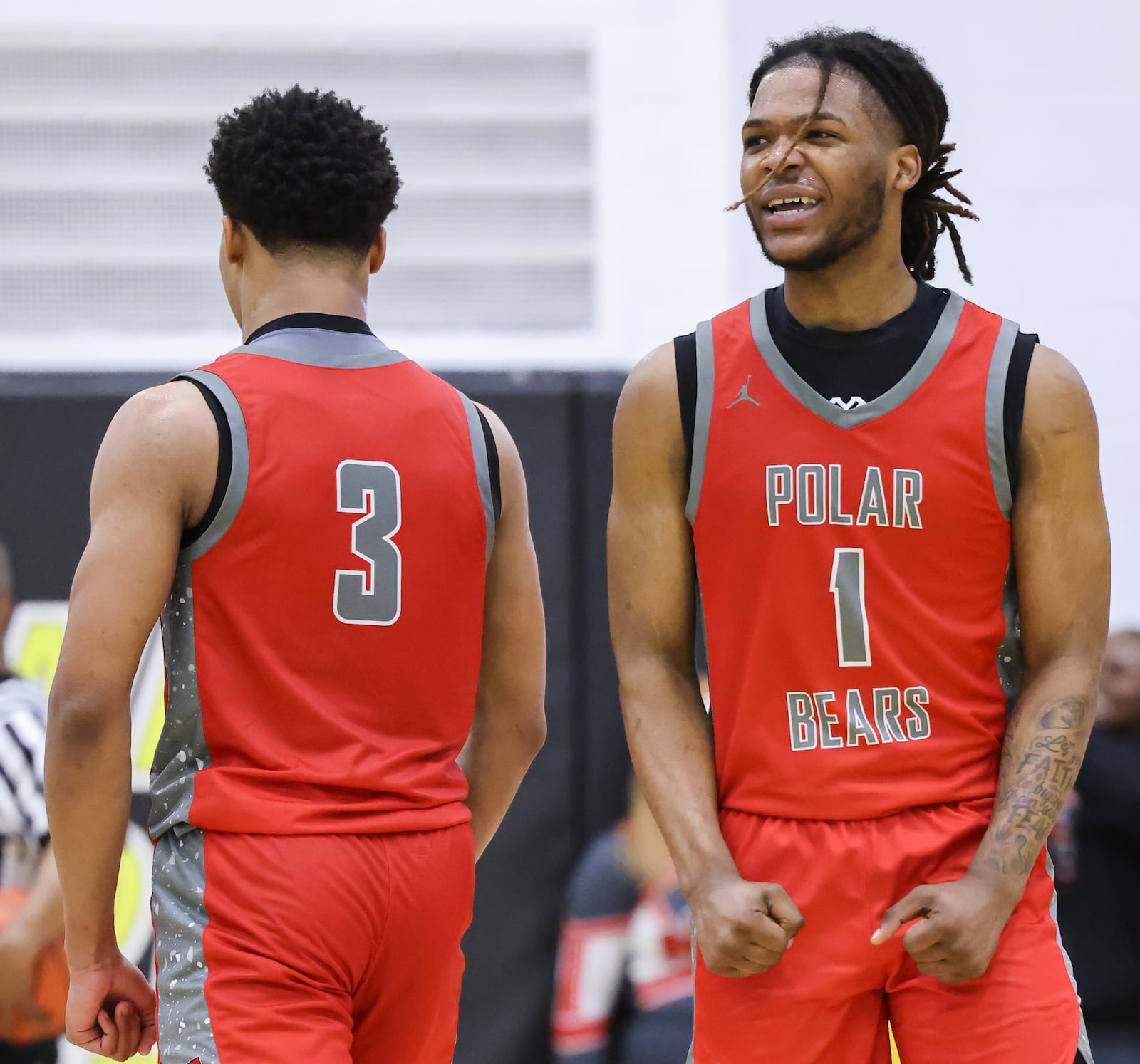 Northridge senior guard Deonte Smith (right) reacts after a basket in the fourth quarter of a Division IV district semifinal on Tuesday, March 3 at Sidney High School. BRYANT BILLING / STAFF