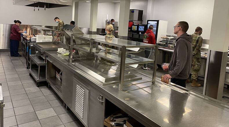 Airmen at Pitsenbarger Dining Hall, Wright-Patterson Air Force Base, observe proper social distances as they order their entrée, starch, vegetables and more on April 17. (U.S. Air Force photo/Jon Vogel)