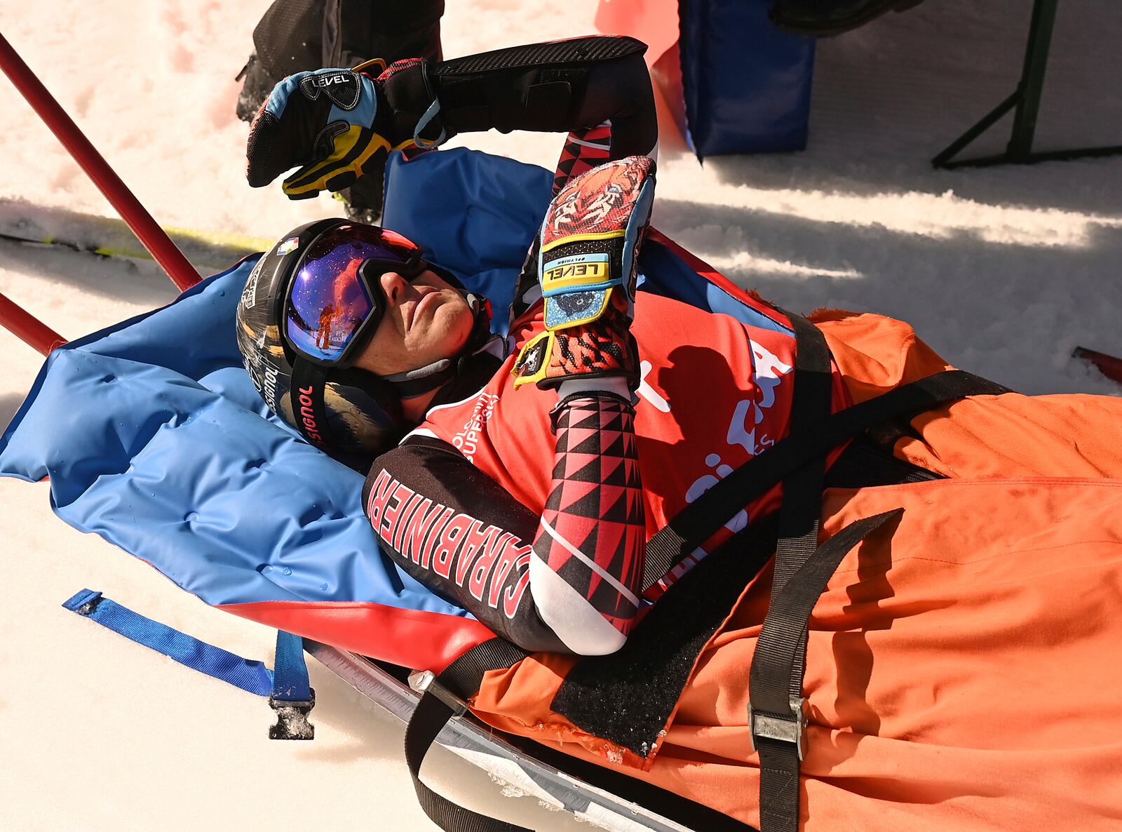 Italy's Federica Brignone is carried away on a toboga after she broke multiple bones in her left leg during a giant slalom crash at the Italian championships in the Lusia ski area, in Val di Fassa, Italy, Thursday, April 3, 2025. (AP Photo/Elvis Piazzi)
