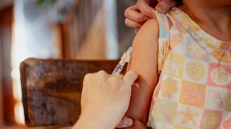 FILE — A child receives a vaccine in Mountain Lakes, N.J., Sept. 16, 2025. The Centers for Disease Control and Prevention upended the childhood vaccine schedule on Monday, Jan. 5, 2026, reducing the number of vaccines recommended for all children, a change condemned by pediatricians and public health experts. (Laila Stevens/The New York Times)