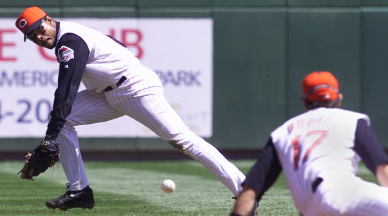 Barry Larkin, the Cincinnati Reds shortstop, goes for a ball that Aaron Boone (right) couldn't get against the Montreal Expos in this file photo.