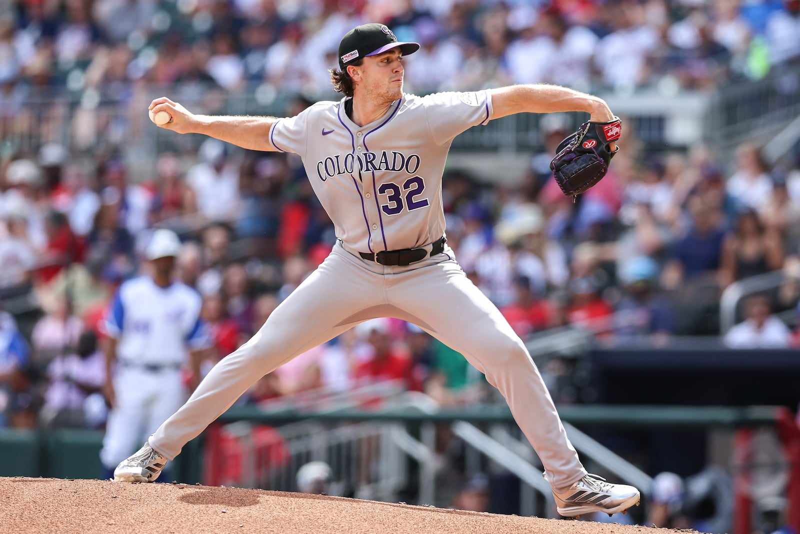 Colorado Rockies pitcher Chase Dollander (32) delivers in the first inning of a baseball game against the Atlanta Braves, Saturday, June 14, 2025, in Atlanta. (AP Photo/Colin Hubbard)