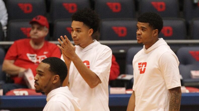 Dayton's Christian Wilson, center, and Jabali Leonard, right, warm up before a game against Capital on Friday, Nov. 2, 2018, at UD Arena.