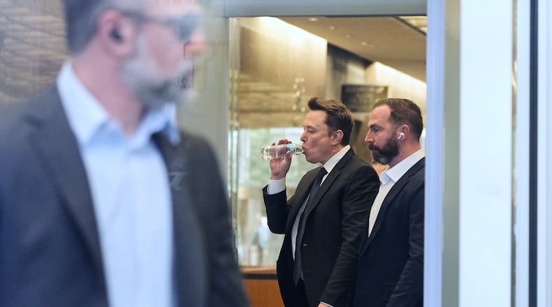 Elon Musk, center, arrives for a Twitter shareholder trial at the U.S. District Court for the Northern District of California, Wednesday, March 4, 2026, in San Francisco. (AP Photo/Godofredo A. Vásquez)