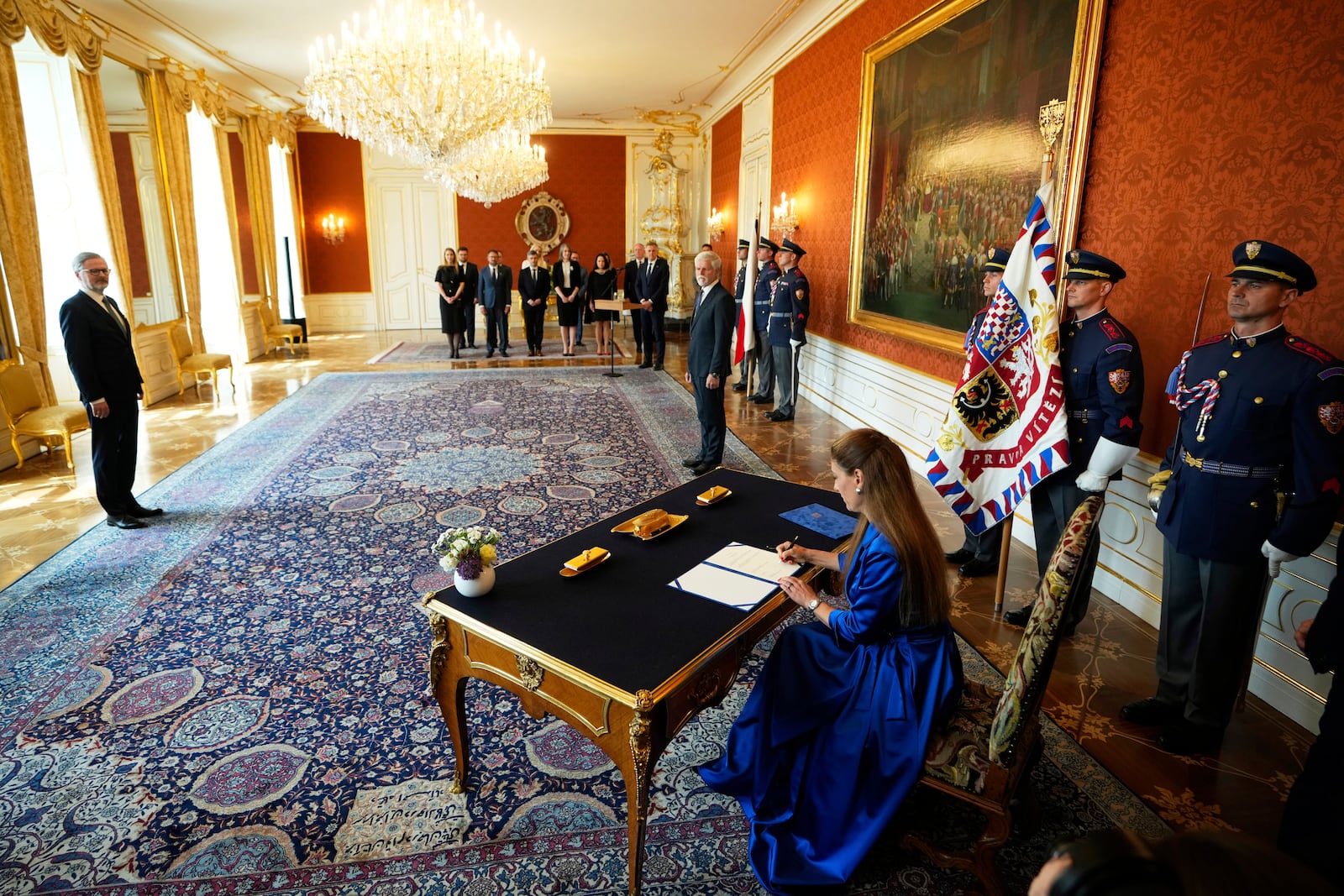 Eva Decroix signs an oath while being appointed as new Justice Minister at the Prague Castle in Prague, Czech Republic, Tuesday, June 10, 2025. (AP Photo/Petr David Josek)