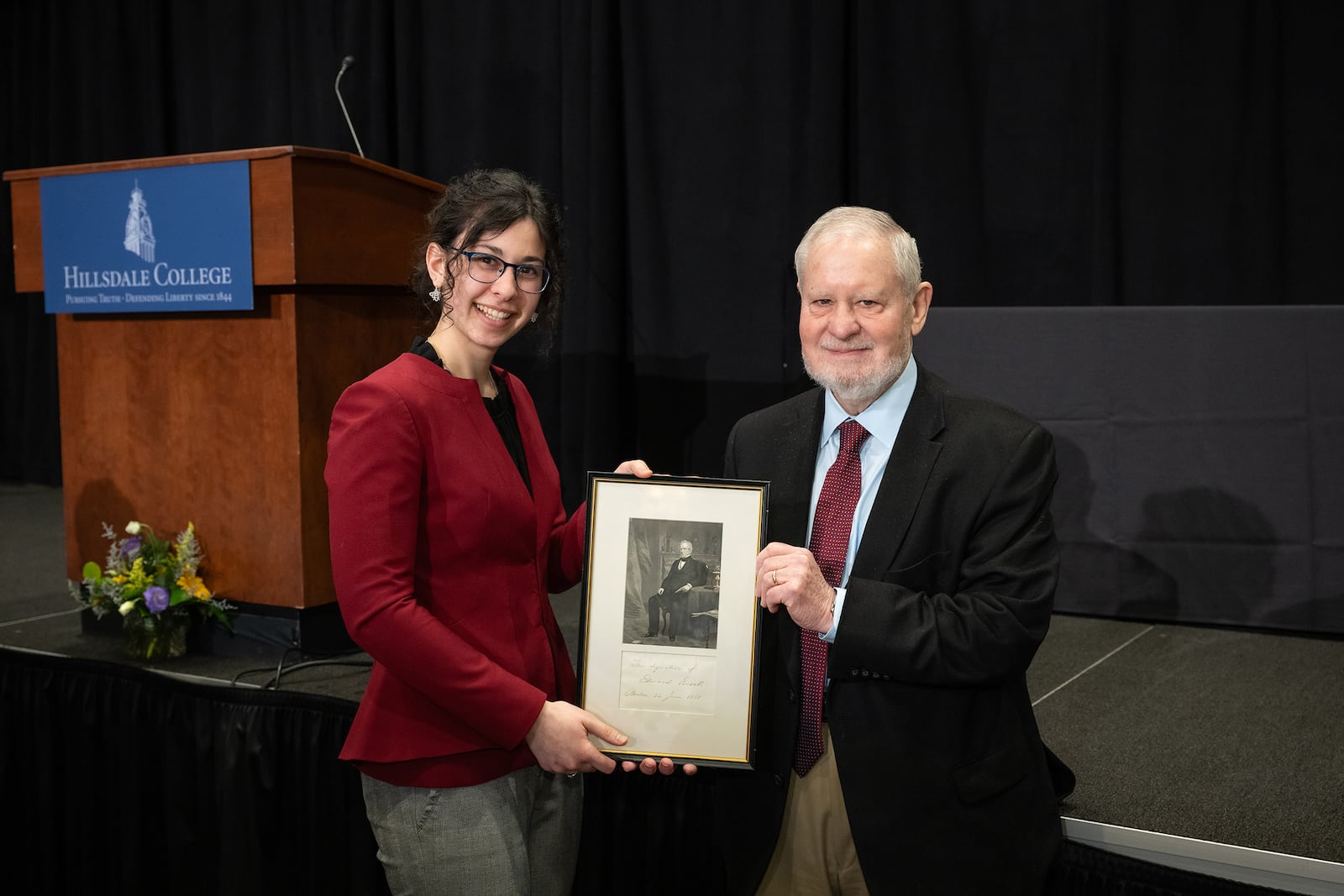 24th annual Everett Prize in Oratory competition at the Searle Center in Hillsdale, MI on March 5, 2024. Schutte (L) receives the prize from Larry P. Arnn, Hillsdale College president.