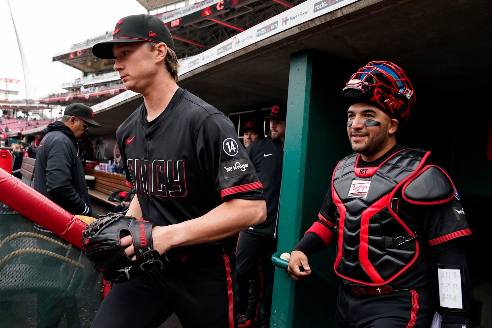 Cincinnati Reds pitcher Brady Singer, front left, leaves the dugout with teammate Jose Trevino, right, prior to a baseball game against the Pittsburgh Pirates, Friday, April 11, 2025, in Cincinnati. (AP Photo/Jeff Dean)