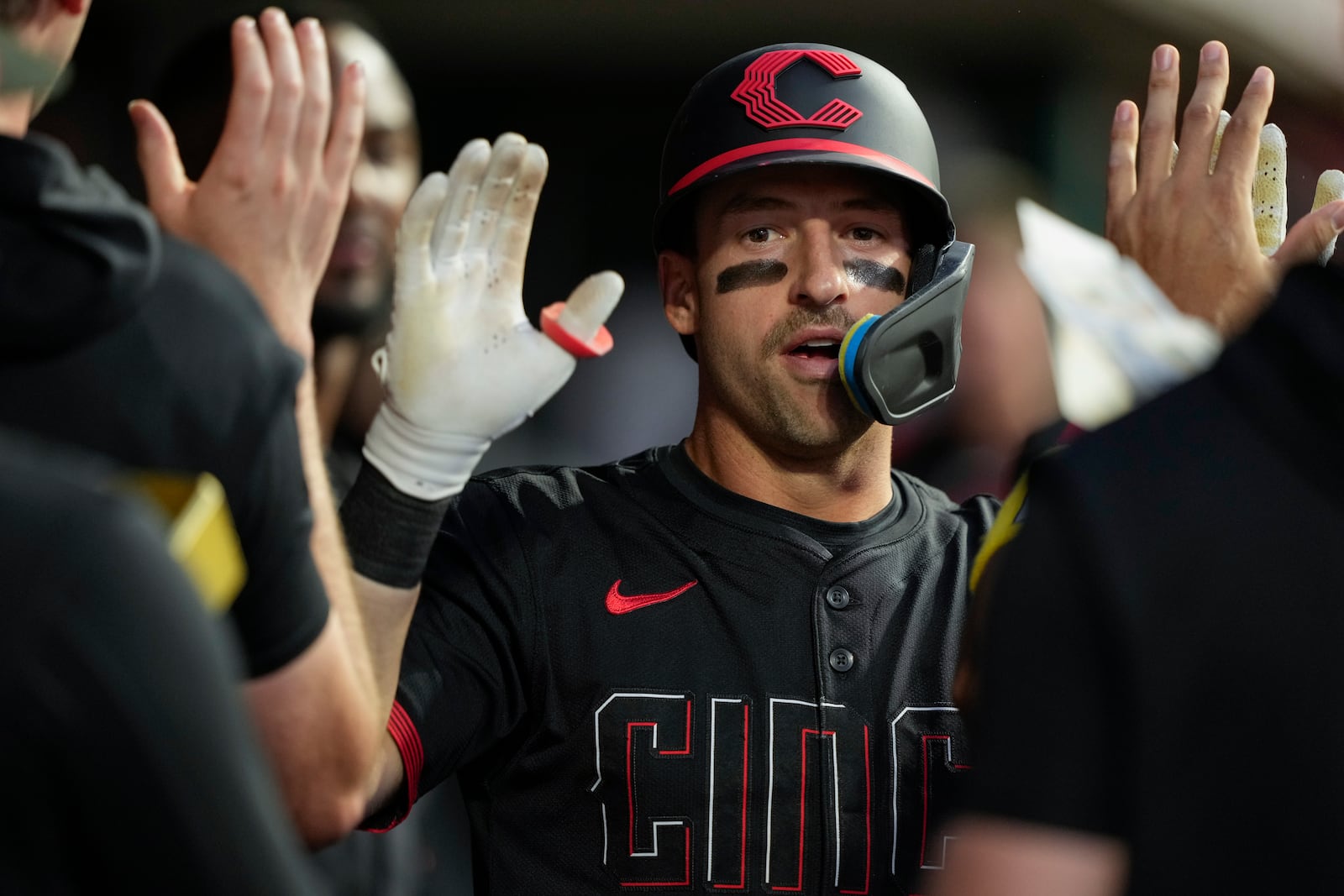 Cincinnati Reds' Spencer Steer celebrates in the dugout after hitting a solo home run during the sixth inning of a baseball game against the St. Louis Cardinals Friday, Aug. 29, 2025, in Cincinnati. (AP Photo/Carolyn Kaster)