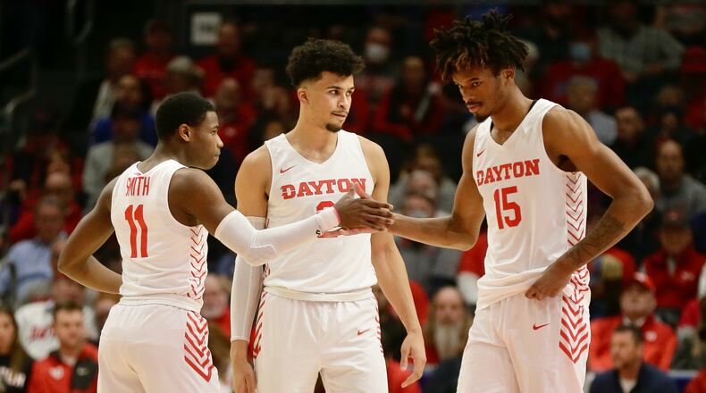 From left: Dayton's Malachi Smith, Toumani Camara and DaRon Holmes II were named the team's MVP on Thursday night. David Jablonski/Staff