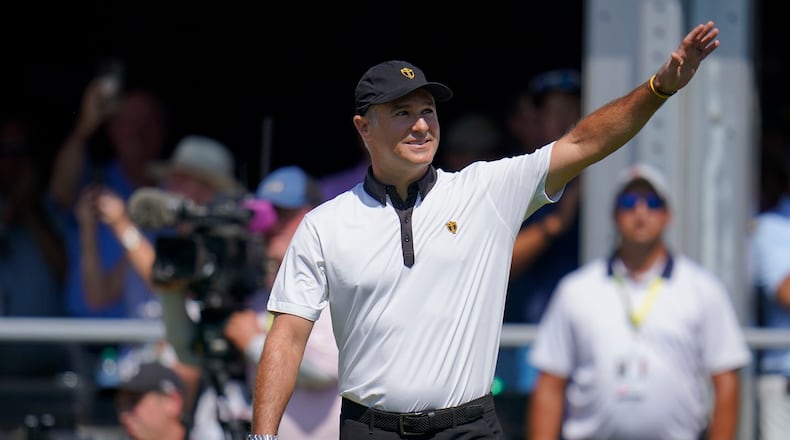 FILE - International team captain Trevor Immelman waves toward the gallery before a foursomes match at the Presidents Cup golf tournament at the Quail Hollow Club, Sept. 22, 2022, in Charlotte, N.C. (AP Photo/Julio Cortez, File)