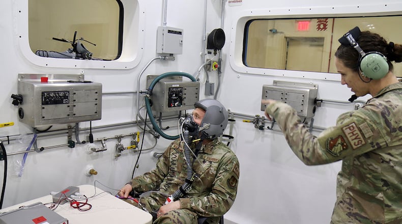 Maj. Sarah Kercher directs Tech. Sgt. Tyler Wineman in preparation for an oxygen system test inside a Research Altitude Chamber at Wright Patterson Air Force Base, April 15. The chamber is one of three at the base that were certified in March for manned research up to 50,000 feet, a benchmark found nowhere else in the Department of Defense. U.S. AIR FORCE PHOTO/JASON SCHAAP