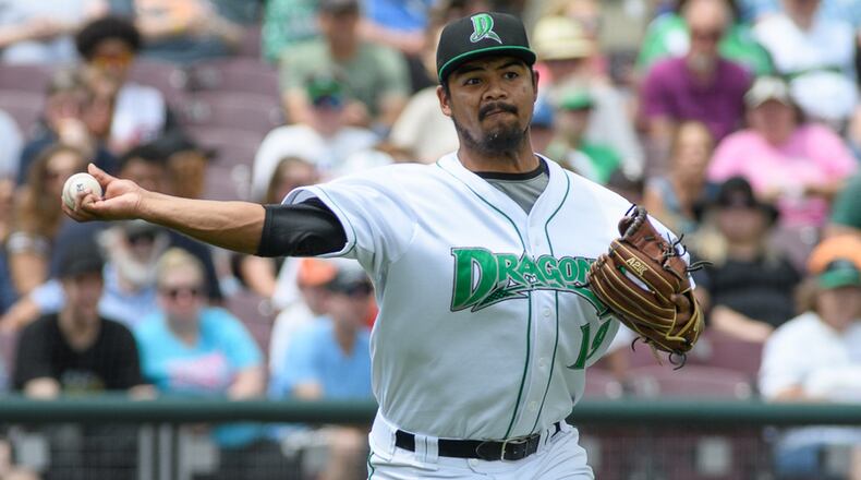 Dragons pitcher Tony Santillan throws to first base during the fourth inning of a game against West Michigan on Monday at Fifth Third Field. Contriubted Photo / Bryant Billing