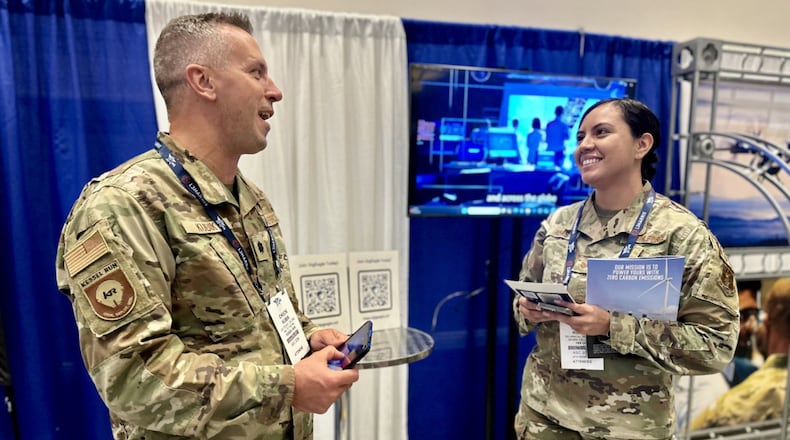 Lt. Col. Chuck Kubik, GigEagle product team lead, speaks with an attendee at the Air Force Association's Air, Space and Cyber Conference, Sept. 16, 2024. GigEagle is an AI-powered Joint talent marketplace connecting skilled DoD talent with critical problem sets in real time. (Air Force photo)