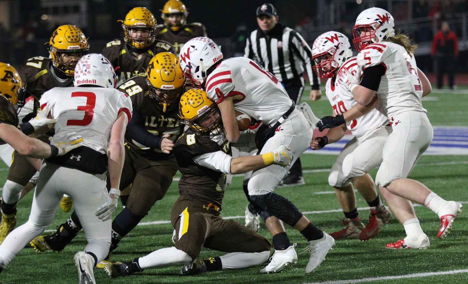 Alter’s Matthew Schimpf tackles Wapakoneta’s Riley Gibson during the Knights’ 21-7 victory over Wapakoneta in the Division III, Region 12 high school football championship at Piqua High School’s Alexander Stadium on Friday, Nov. 16, 2018. MICHAEL COOPER / CONTRIBUTED