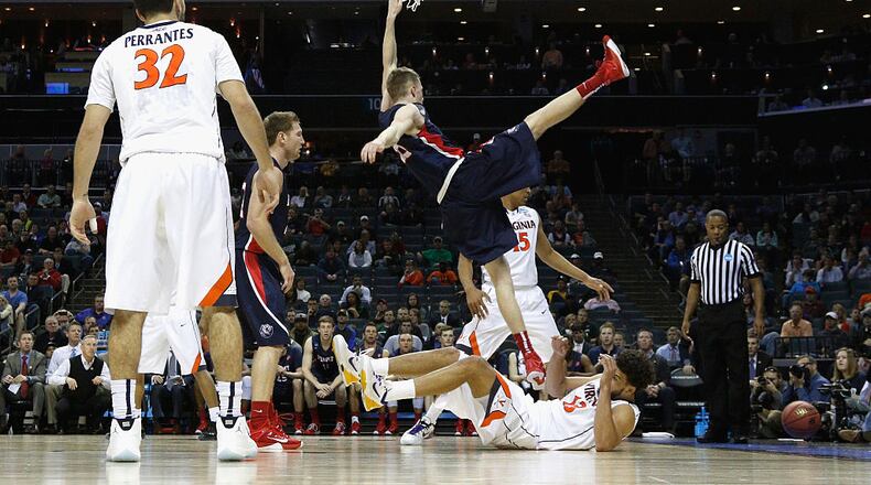 CHARLOTTE, NC - MARCH 20: Evan Bradds #35 of the Belmont Bruins falls at the basket against the Virginia Cavaliers during the second round of the 2015 NCAA Men’s Basketball Tournament at Time Warner Cable Arena on March 20, 2015 in Charlotte, North Carolina. (Photo by Bob Leverone/Getty Images)