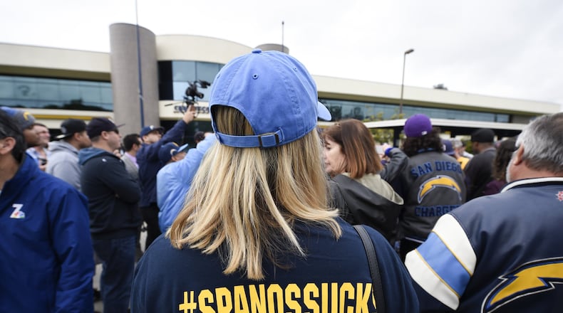 A fan mocks team owner Dean Spanos on Thursday after learning the San Diego Chargers are moving to Los Angeles. Other fans burned team gear, reminiscent of when the Cleveland Browns left for Baltimore. (AP Photo/Denis Poroy)