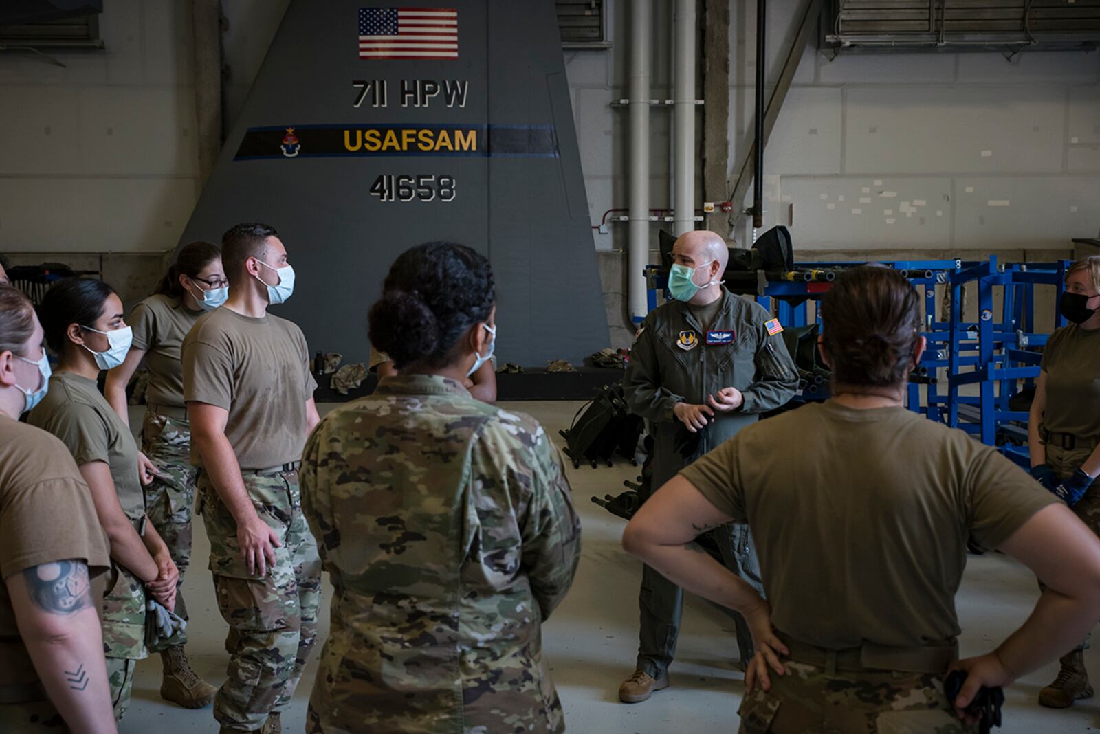 Tech. Sgt. Robert Van Aken, an instructor and medical technician with the U.S. Air Force School of Aerospace Medicine, speaks to Airmen from the 88th Medical Group on Aug. 12 at Wright-Patterson Medical Center. The training equipped medics with proper skills to load and unload wounded or injured patients. U.S. AIR FORCE PHOTO/RICHARD ELDRIDGE