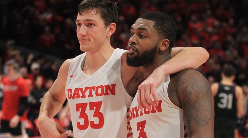 Dayton’s Ryan Mikesell and Trey Landers leave the court after a victory against Davidson on Friday, Feb. 28, 2020, at UD Arena. David Jablonski/Staff
