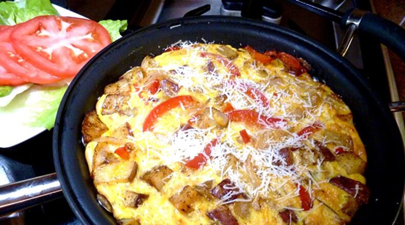 Cheesy frittata with lettuce and tomatoes. (Linda Gassenheimer/TNS)