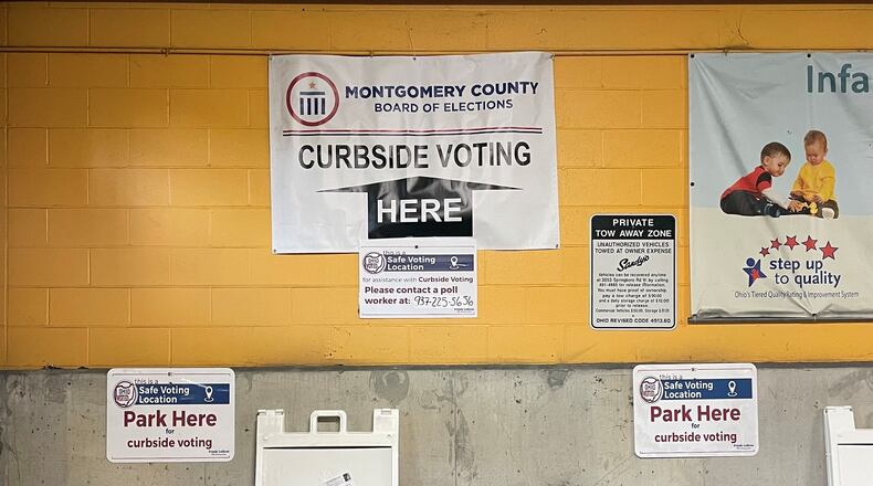 Signs in the county administration building garage downtown show Montgomery County voters where to pull in for curbside voting.