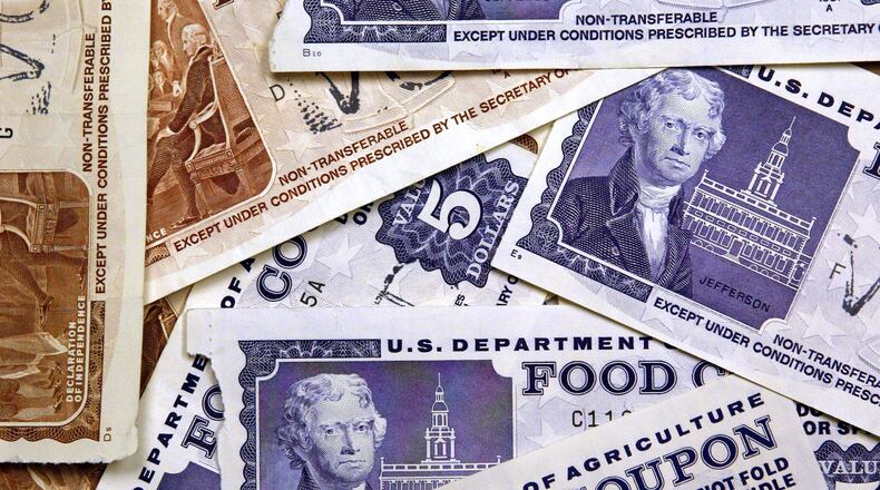 Older, traditional food stamps are displayed. (Photo by Tim Boyle/Getty Images)