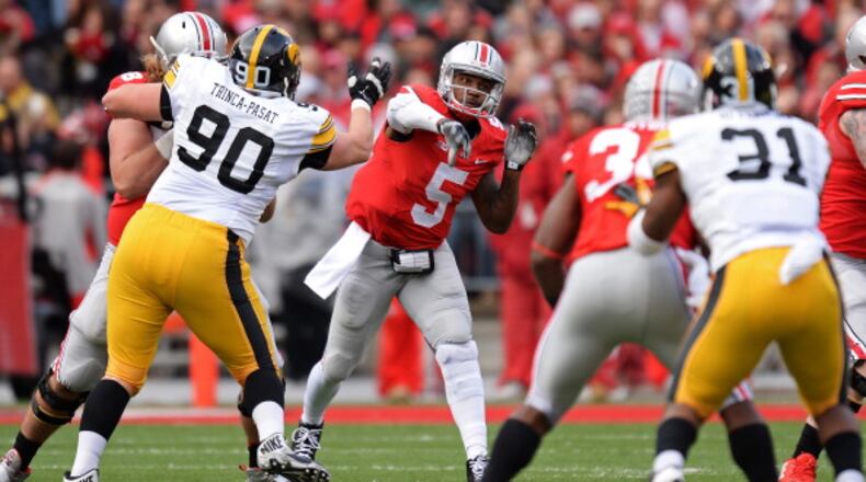 COLUMBUS, OH - OCTOBER 19: Quarterback Braxton Miller #5 of the Ohio State Buckeyes passes downfield in the second quarter against the Iowa Hawkeyes at Ohio Stadium on October 19, 2013 in Columbus, Ohio. (Photo by Jamie Sabau/Getty Images)