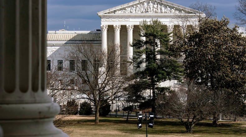 FILE - The Supreme Court is seen in the distance, framed through columns of the U.S. Senate at the Capitol in Washington, Feb. 20, 2025. (AP Photo/J. Scott Applewhite, File)