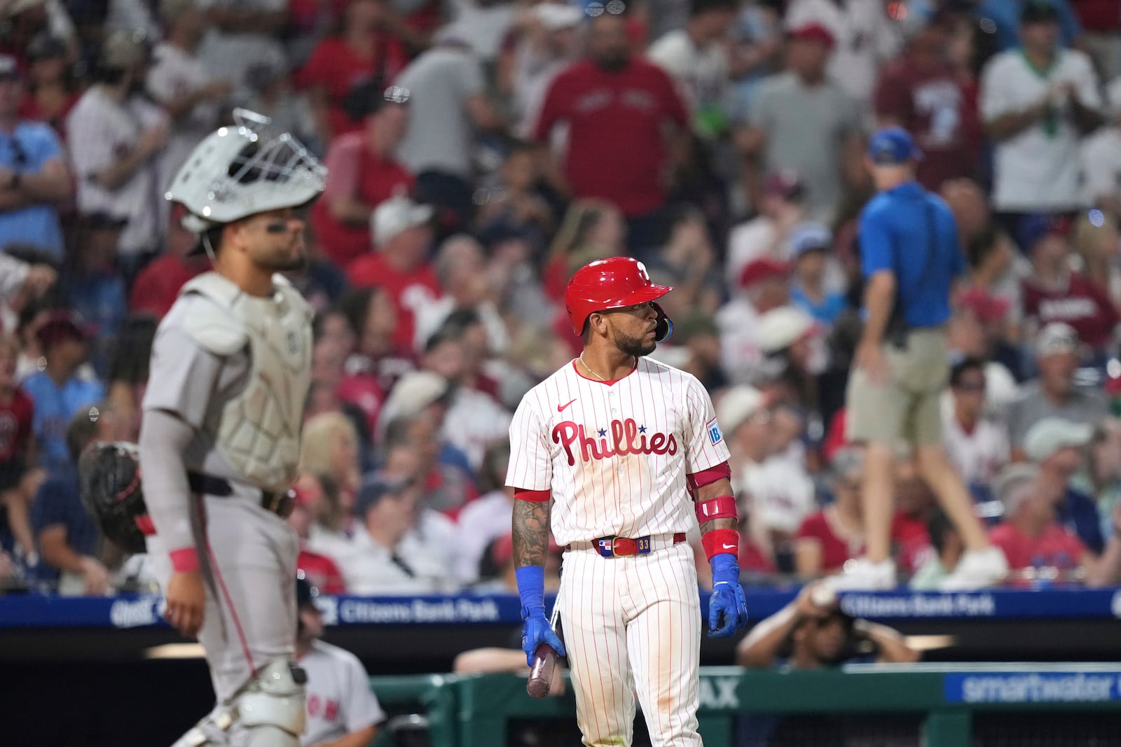 Philadelphia Phillies' Edmundo Sosa, right, and Boston Red Sox catcher Carlos Narváez wait for umpires to make a catcher's interference call with the bases loaded during the 10th inning of a baseball game Monday, July 21, 2025, in Philadelphia. (AP Photo/Matt Slocum)