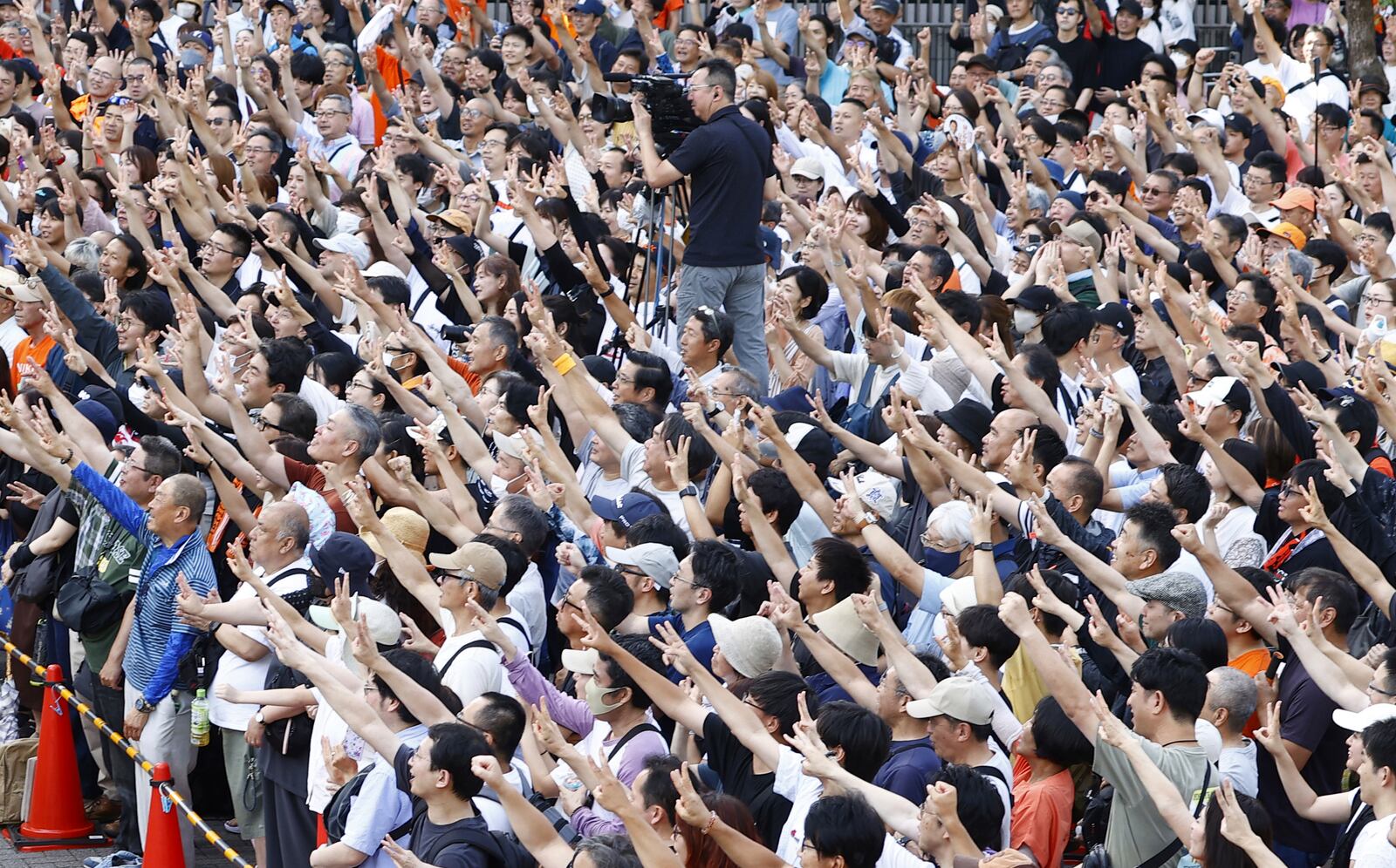 People gather during an election campaign of Sanseito party for the upper house election in Yokohama, Saturday, July 19, 2025. (Kyodo News via AP)