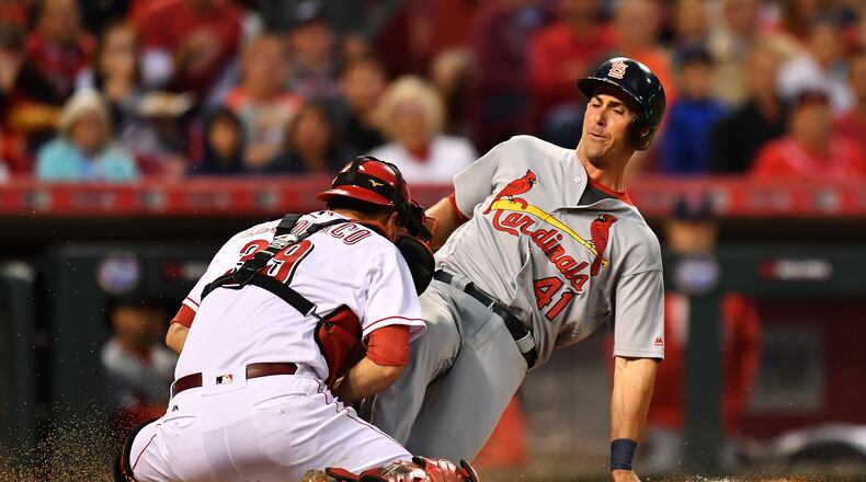 Reds catcher Devin Mesoraco tags out Eric Fryer of the Cardinals at home plate in a June 7 game at Great American Ball Park.