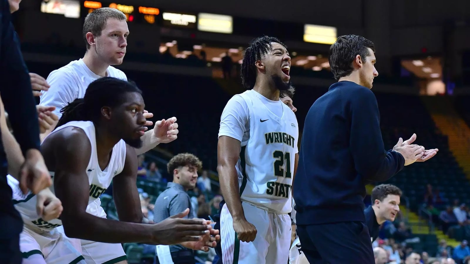 Wright State players, including Logan Woods (21), and coach Clint Sargent on the sidelines during their home-opening win over Ohio Christian in November of 2024. JOSEPH CRAVEN/WRIGHT STATE ATHLETICS